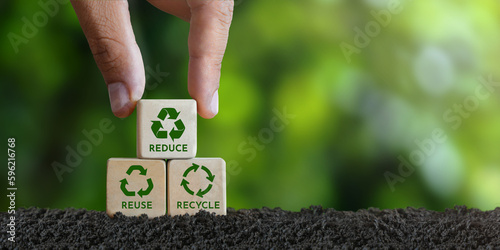 concept, reduce, reuse, recycle, recycle symbol Hand placed wooden block with green recycle icon. Ecology. Ecological metaphor for ecological waste management reduce, reuse, recycle.