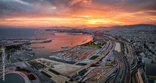 Fototapeta Naklejka Na Ścianę i Meble -  Aerial view of the Faliro Delta and Kallithea district in south Athens, Greece, with yacht marinas and road infrastructure during a colorful sunset