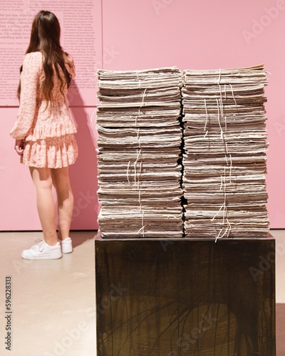 Girl in gallery reading text