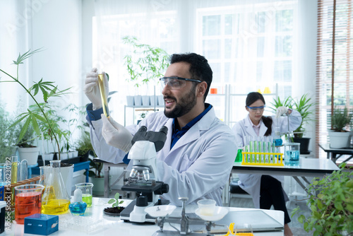 asian botanist working at laboratory
