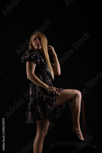 beautiful blonde in a dark room on a black background