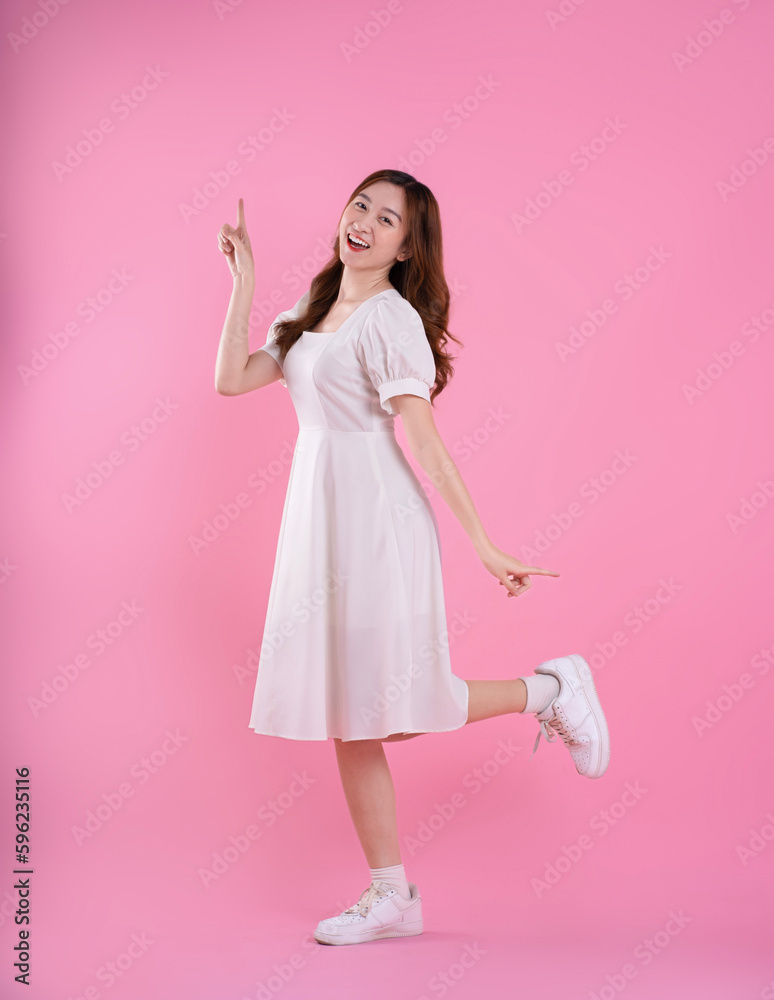 full body image of asian woman in skirt posing on pink background full body image of asian woman in skirt posing on pink background