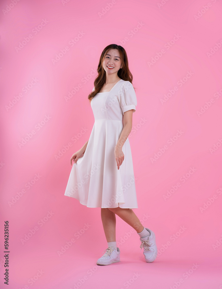 full body image of asian woman in skirt posing on pink background full body image of asian woman in skirt posing on pink background