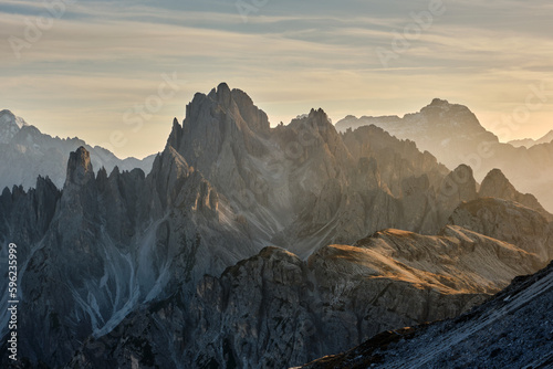 Beautiful sunset illuminating the rocky peaks with warm and soft light in autumn on the dolomites in italy
