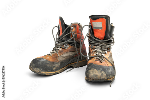 Obraz na płótnie A pair of well worn old leather hiking boots used to protect your feet when walking in the mountains isolated against a transparent background. w salonie
