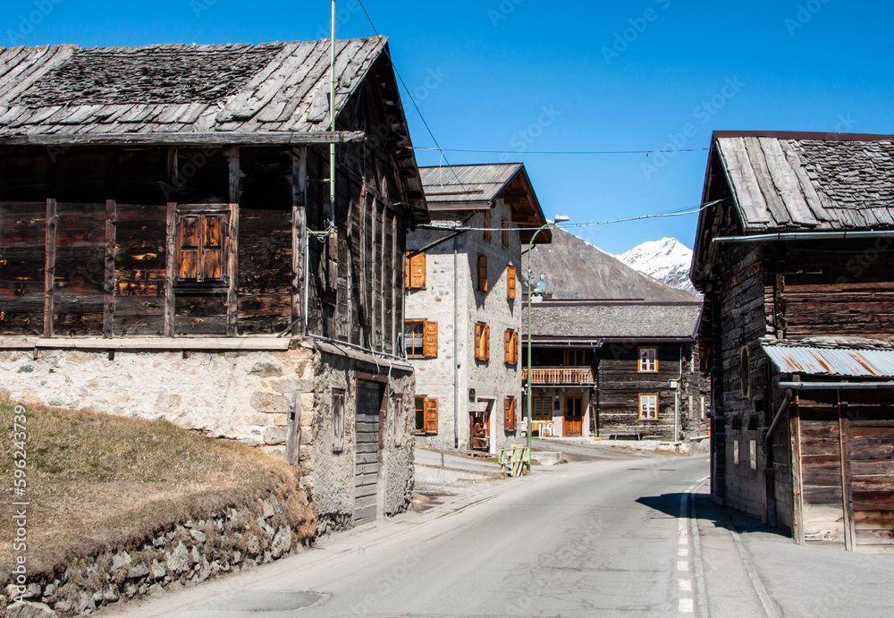Livigno village, street view with old wooden houses, Italy, Alps