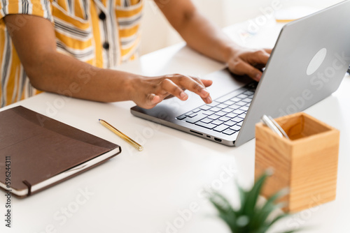 Crop freelancer working on laptop