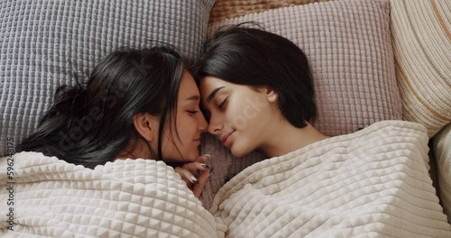 Couple of women hug each other warmly and relax at home in the bedroom.Embrace and holding each other. LGBT concept. Couple, Romance and portrait of lesbian couple enjoying. Pride Event, LGBT rights. photo