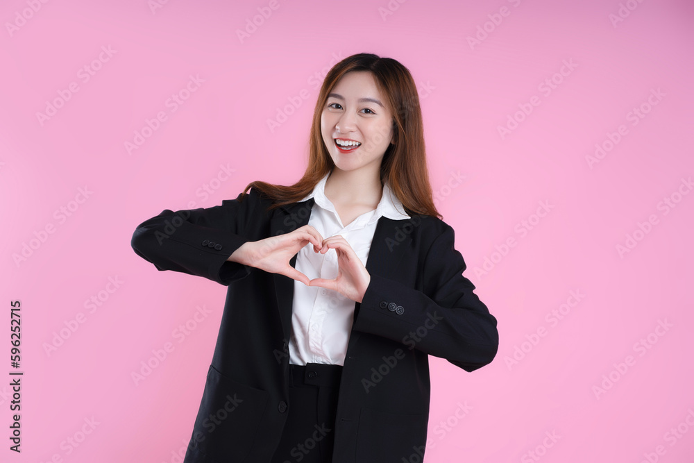 image of businesswoman posing on pink background image of businesswoman posing on pink background
