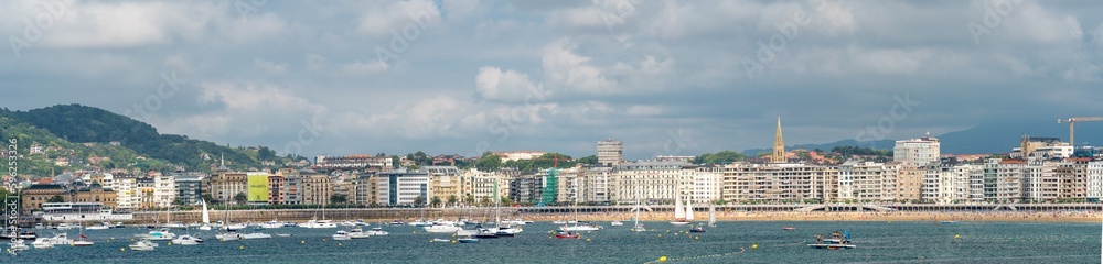 SAN SEBASTIAN, Spain July 08 2022: Panoramic view of San Sebastian - Donostia city. Situated in north of Spain, Basque Country. Famous travel destination. View of La Concha Bay, Santa Clara Island 