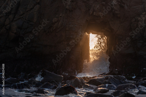 Detail of the Keyhole arch at Pfeiffer beach, with the setting sun to be just behind it.