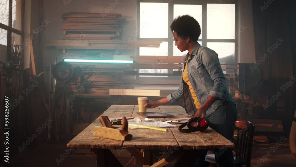 African American woman in wood workshop. African American woman in wood workshop.