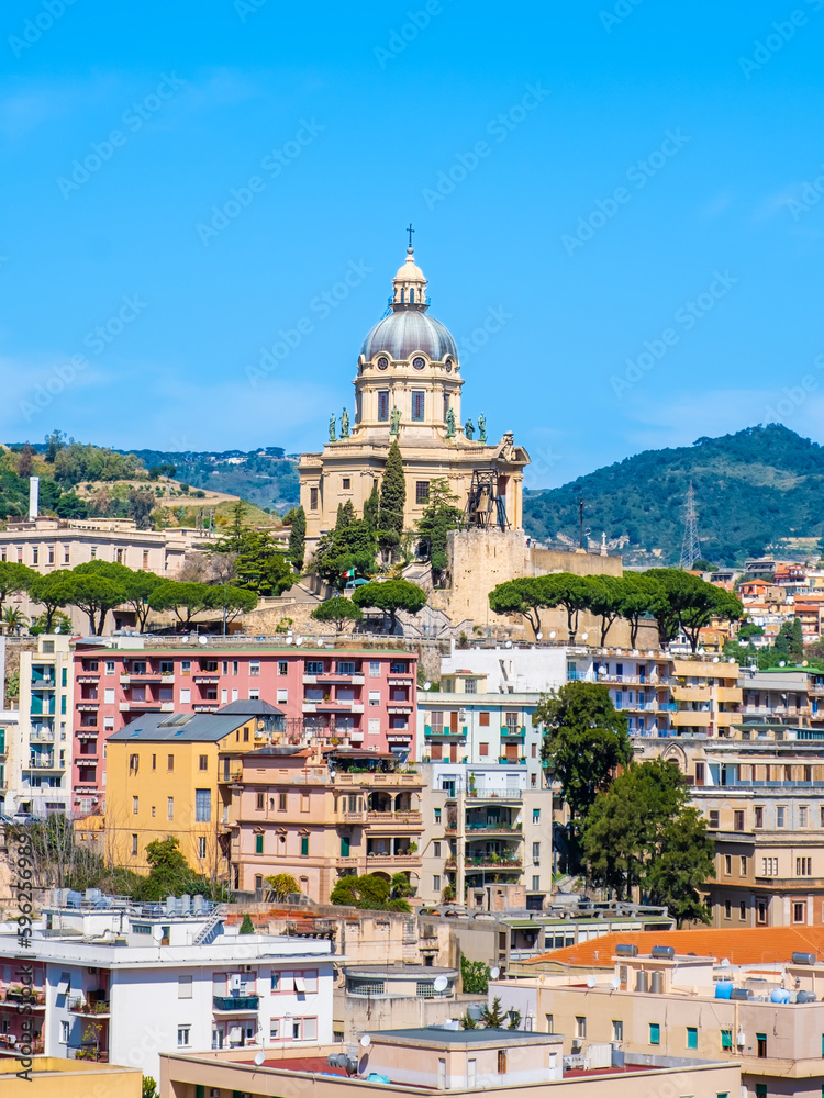 View of Messina on Sicily island, Italy. Votive Temple of Christ the King or Tempio di Cristo Re on hill over town as memorial to Italian soldiers