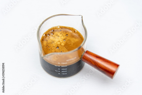 Shot coffee in a measuring cup on a white background 