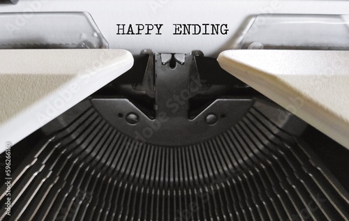 Vintage typewriter with typed text HAPPY ENDING - means ending of story or or events in which the people involved are all happy - when all problems are solved, finish writing a book or a novel
