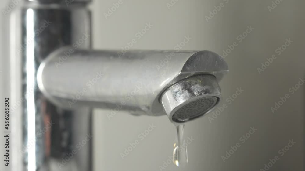 Water droplets dripping from tap quickly Close up Water droplets dripping from tap quickly Close up