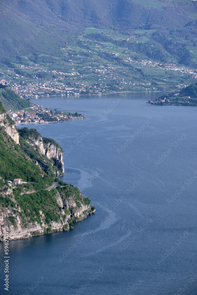 Landscape with a view of a beautiful rugged coast of Lake Iseo and small villages overlooking the lake and Montisola on the right Landscape with a view of a beautiful rugged coast of Lake Iseo and small villages overlooking the lake and Montisola on the right