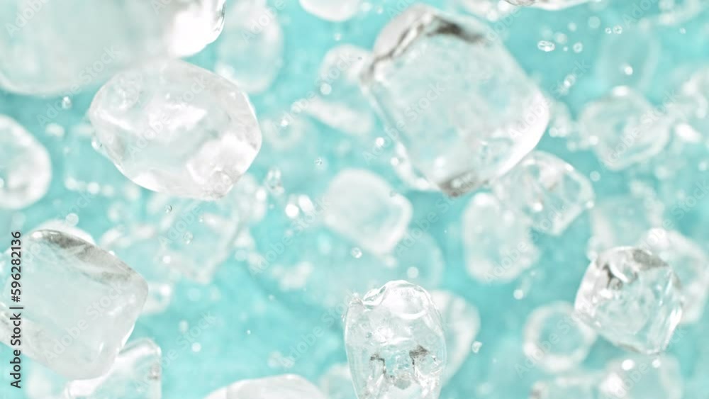 Super slow motion of rotating ice cubes, top view shot. Filmed on high speed cinema camera, 1000 fps, placed on high speed cine bot, following the object. Speed ramp effect. Super slow motion of rotating ice cubes, top view shot. Filmed on high speed cinema camera, 1000 fps, placed on high speed cine bot, following the object. Speed ramp effect.
