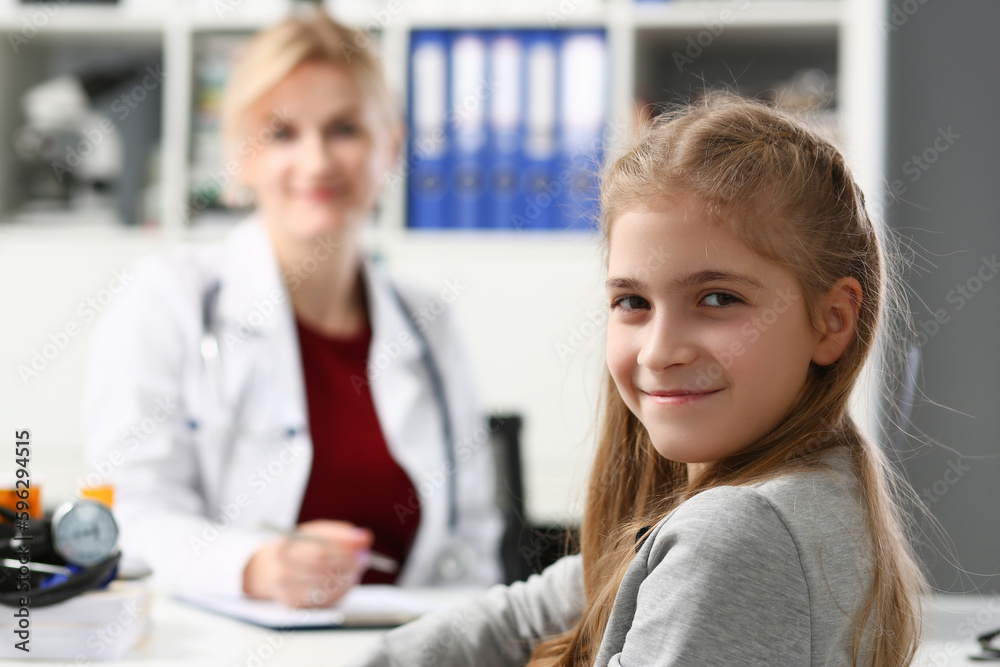 Portrait of child girl at reception at the pediatrician doctor in clinic. Medical examination of children and insurance Portrait of child girl at reception at the pediatrician doctor in clinic. Medical examination of children and insurance