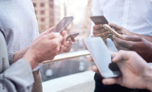 When you need to innovate, you need collaboration.. Cropped shot of a group of unrecognizable businesspeople using their cellphones.