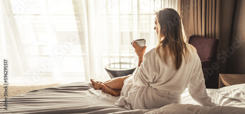 Young woman with bathrobe have a Breakfast in bed