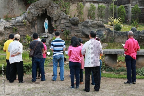 People praying in front of Maria cave. rRosary prayer. Catholic prayer