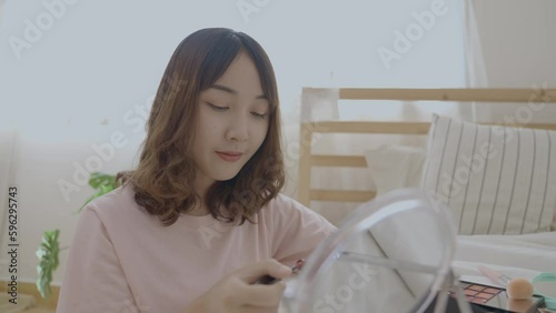Beauty concept of 4k Resolution. Asian girls make makeup on the bed in the bedroom.