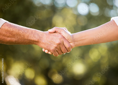 We can do this together. Shot of two unrecognisable men shaking hands outdoors.