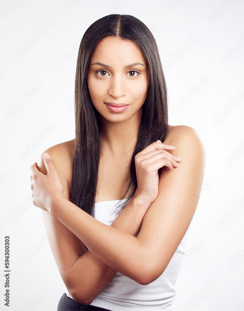 Nothing feels better than loving yourself. Shot of a young woman posing against a white background with healthy looking hair. Nothing feels better than loving yourself. Shot of a young woman posing against a white background with healthy looking hair.
