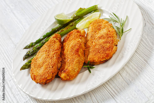 breaded chicken breasts with asparagus and lime