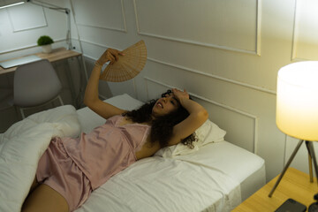 Distressed woman having sleeping problems in the summer