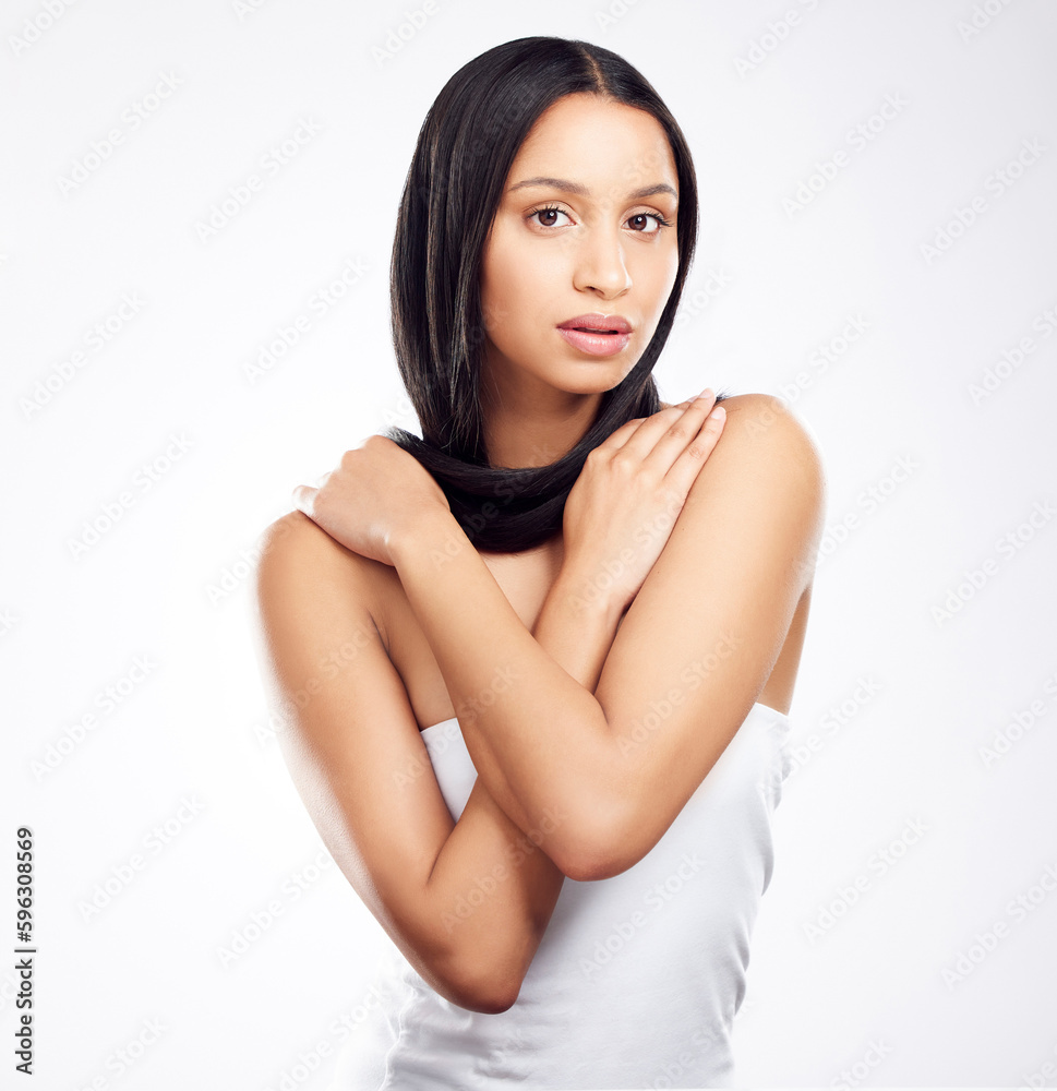 What products do you use for your hair. Shot of a young woman posing against a white background with healthy looking hair. What products do you use for your hair. Shot of a young woman posing against a white background with healthy looking hair.