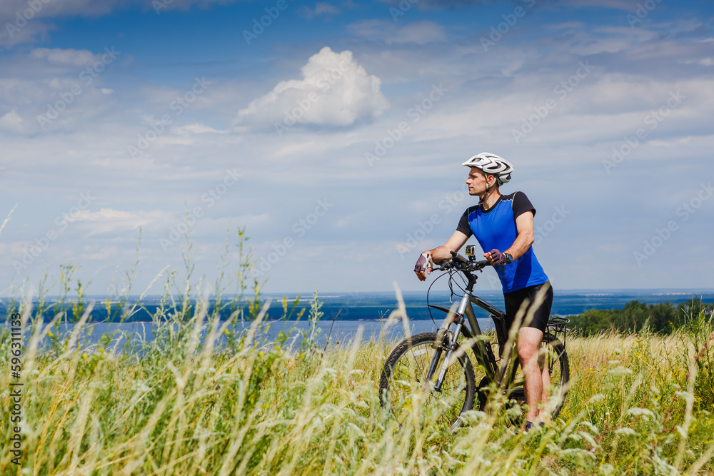 Mountain Bike cyclist on a sunny day. Healthy Lifestyle and Travel Concept Mountain Bike cyclist on a sunny day. Healthy Lifestyle and Travel Concept