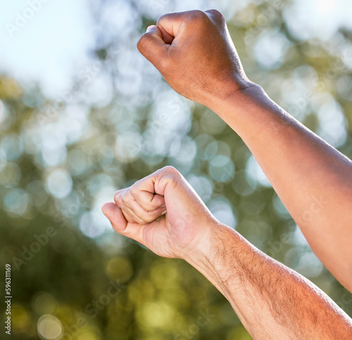 Keep fighting on. Shot of two unrecognisable men raising their fists in defiance outdoors. © Jade M/peopleimages.com