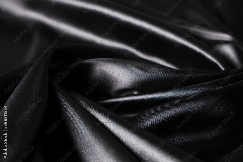 Fototapeta premium Background black twisted silk fabric,abstract texture satin fabric.