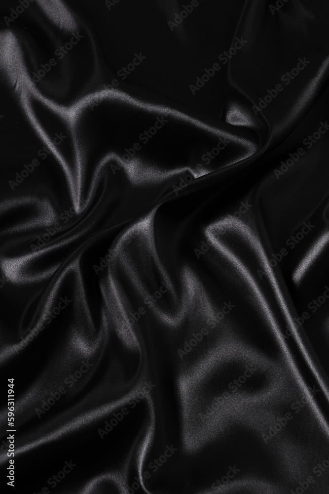 Fototapeta premium Silk fabric, abstract wavy black satin fabric background.
