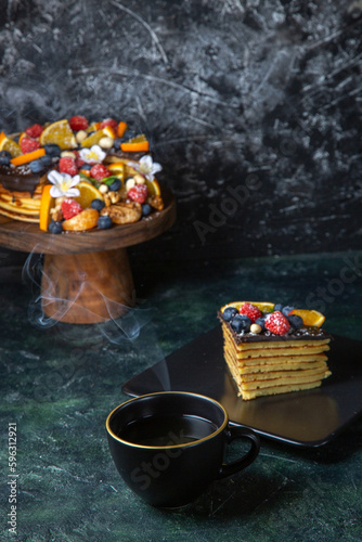 front view delicious fruit cake with cup of tea dark background tea pie dough dessert sweet biscuits cake sugar