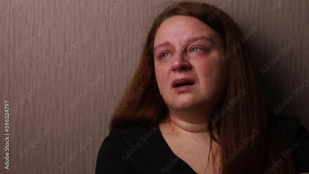 Upset woman bitterly cry looking up near room wall. Tears roll down cheeks, tearful eyes and swollen face. Splash out emotions, sob violently. Emotional breakdown, stress. Depression and hysterics. Upset woman bitterly cry looking up near room wall. Tears roll down cheeks, tearful eyes and swollen face. Splash out emotions, sob violently. Emotional breakdown, stress. Depression and hysterics.
