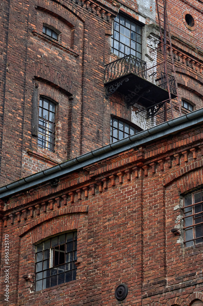 Old historic abandoned red brick halls of former textile factories in Poland