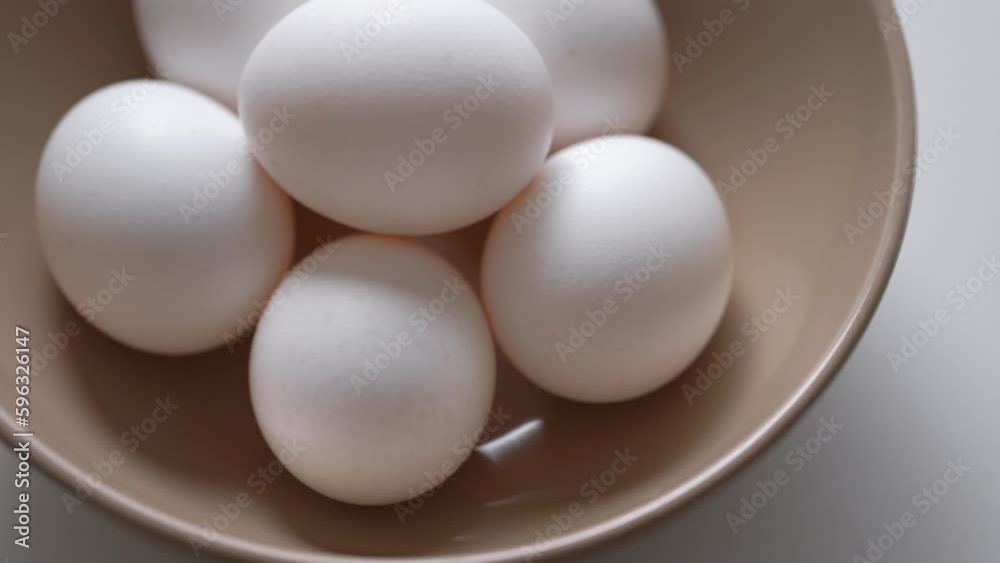 Hand Takes White Egg From Eggs Packed. Chicken egg rotates on a white background. Close-up of an egg. Fresh Protein Food. Chicken Eggs In Eggshell Cardboard Box. Chicken Coop Package. Raw Food Breakfa Hand Takes White Egg From Eggs Packed. Chicken egg rotates on a white background. Close-up of an egg. Fresh Protein Food. Chicken Eggs In Eggshell Cardboard Box. Chicken Coop Package. Raw Food Breakfa