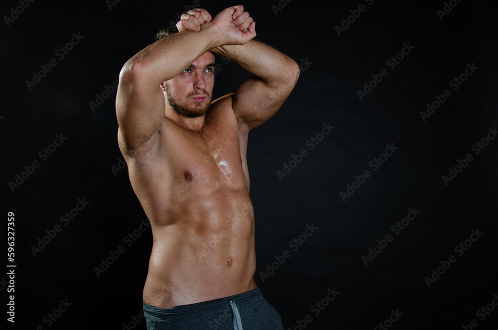 Young handsome trainer posing in the studio. A man with a beautiful athletic body. Young handsome trainer posing in the studio. A man with a beautiful athletic body.