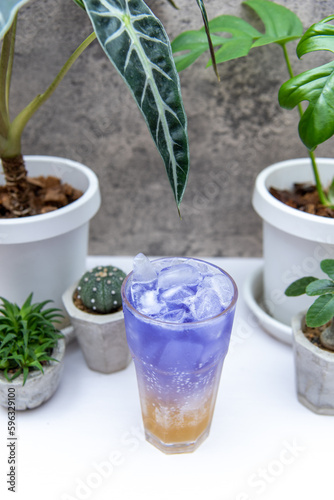 Butterfly pea flower juice with honey and lemon soda on white table