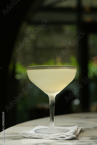 Margarita cocktail glass with martini and dry lemon slice