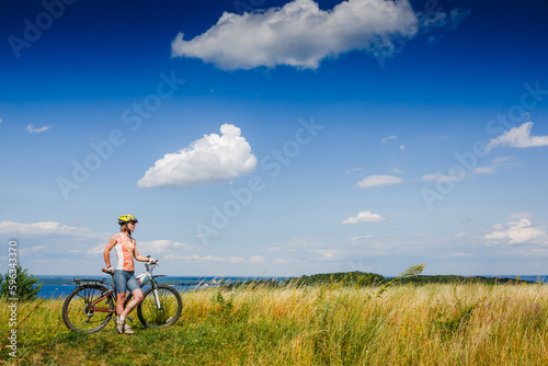 Fototapeta Naklejka Na Ścianę i Meble -  Mountain biking - woman with bike enjoy summer vacation