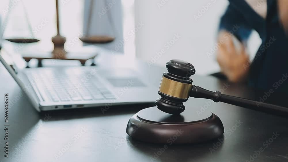Business and lawyers discussing contract papers with brass scale on desk in office. Law, legal services, advice, justice and law concept picture with film grain effect Business and lawyers discussing contract papers with brass scale on desk in office. Law, legal services, advice, justice and law concept picture with film grain effect