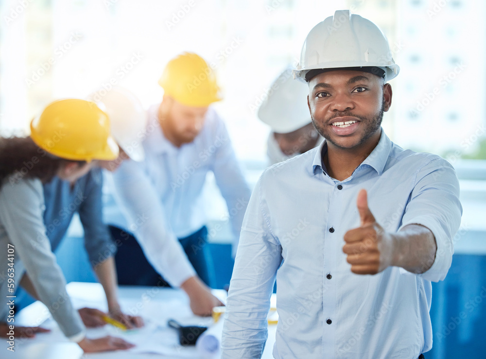 This is going according to plan. Shot of a young businessman showing a thumbs up at work. This is going according to plan. Shot of a young businessman showing a thumbs up at work.