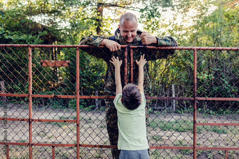 Soldier seturning home and greeted by son. An overjoyed boy is waiting to hug his dad who is returning after military service. Soldier seturning home and greeted by son. An overjoyed boy is waiting to hug his dad who is returning after military service.