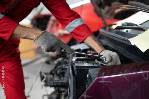 Wallpaper Mural Mechanic man hands using spanner tighten car battery at auto car garage service. Car repair and maintenance concept. Torontodigital.ca