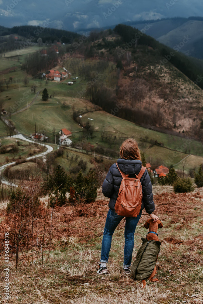 Woman and Vizsla Dog Hiking in Mountains