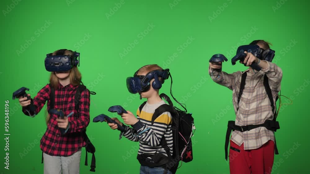 Teenage children use VR headset helmets to play an imitation game on a